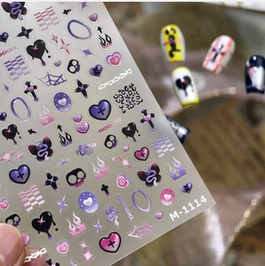 Macro detail of M-1114 nail art stickers featuring purple heart and flame patterns