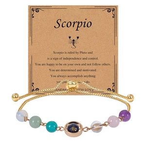 Detailed close-up of Scorpio zodiac bracelet with gold chain and colorful natural stone beads
