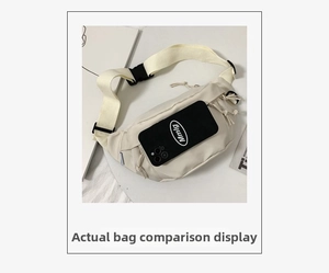 Detail view of cream nylon chest bag with phone for size comparison and adjustable strap