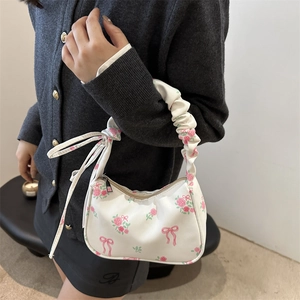 White floral canvas shoulder bag with pink roses and bow prints featuring ruffled handle
