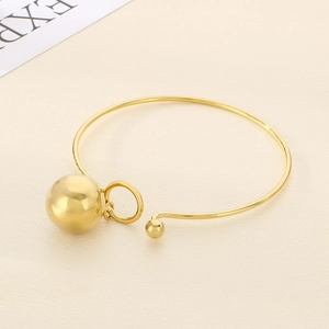 Minimalist gold ball pendant knot cuff bracelet with a polished metallic mirror finish