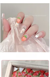 Detail of 3D resin fruit nail charms showing ice-transparent texture and embossed carving