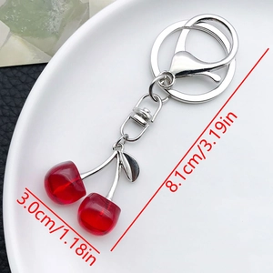 Close-up of red resin cherry keychain showing product dimensions and metal hardware