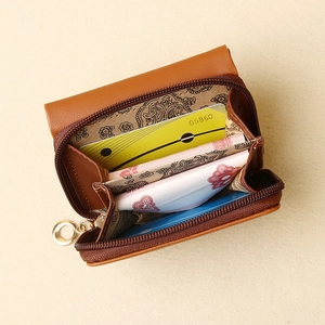 Interior view of the brown leather mini wallet showing card slots and compartments
