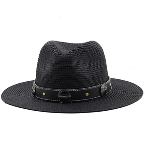 Black straw Panama hat with leather band and vintage metal studs on white background