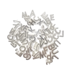 Macro view of silver metal alphabet beads for DIY jewelry making and crafts