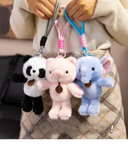 Detail view of plush animal keychains with woven lanyards and 'Fashion' wood tags