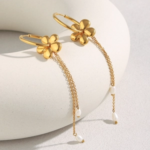 Detailed view of 18K gold plated flower earrings with elegant long pearl tassels