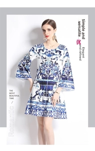 Detail of blue and white porcelain print dress with elegant flared sleeves and round neck