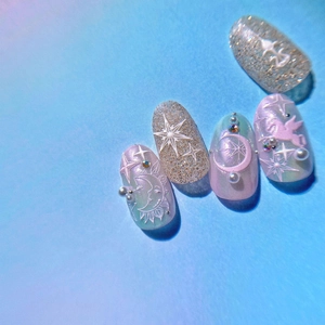 Detail of 5D embossed nail charms featuring angel, stars, and moon with pastel gradients