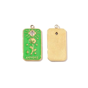 Detailed macro view of colorful enamel lovers pendants with flower patterns in gold