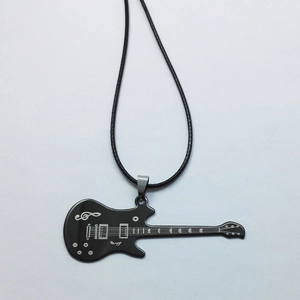 Detail view of a black guitar pendant necklace with silver music symbols and cord chain