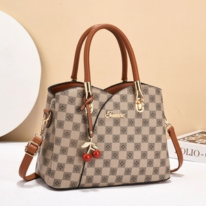 Elegant checkered women's handbag in brown and beige with a cherry charm accessory