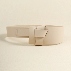 Detail of minimalist beige PU leather wide belt with unique fold knot closure design