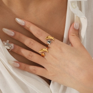 Close-up of adjustable 18K gold and silver celestial star and moon open rings for women