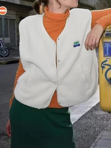 Women sleeveless white fleece vest with V-neck and buttons in street style outfit