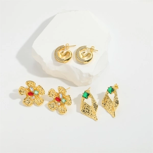 Three pairs of vintage hammered gold flower and octopus-inspired zircon earrings set