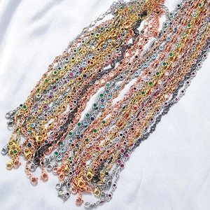 Luxury copper necklace and bracelet set with colorful round cubic zirconia on white silk