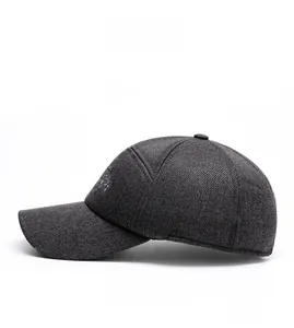 Detail view of dark grey baseball cap showing thick wool-like fabric and white embroidery
