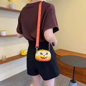 Halloween pumpkin lantern crossbody bag with smiling face pattern and wide shoulder strap