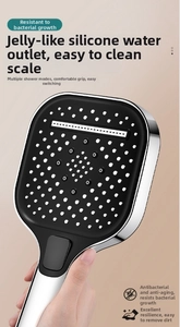 Detail of square shower head with anti-clog silicone nozzles and mode switch button