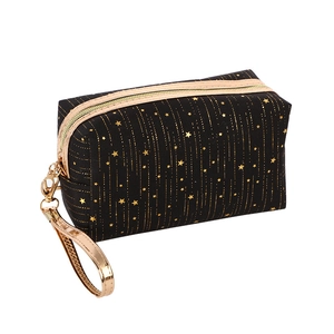 Portable black cosmetic bag with gold star patterns and a metallic wrist strap