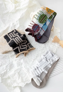 Detail of sheer glass silk socks with geometric patterns and embroidery textures
