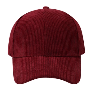 Detailed texture of burgundy corduroy fabric on a structured classic baseball cap