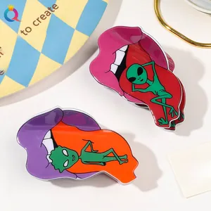 Close-up of funny alien claw clips with open mouth and tongue design in bright colors