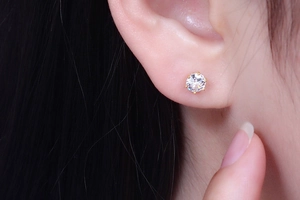 Classic six-prong gold plated silver stud earring with clear zircon shown on model ear