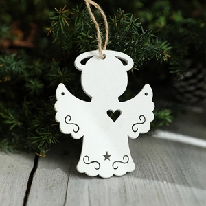 Nordic wooden angel Christmas ornament with star cutouts hanging on pine branches