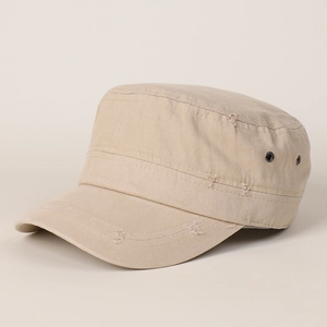 Detail of distressed brim and breathable metal eyelets on a beige cotton cadet cap