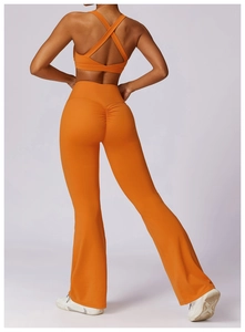 Detail of orange cross-back sports bra and scrunch butt flare leggings for women