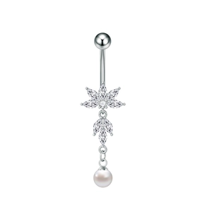Detail of silver belly ring with flower zircon inlay and a dangling white pearl charm