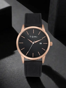Detailed close-up of TOMI watch with black dial, rose gold case and date window