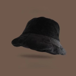 Detailed view of thick black faux rabbit fur bucket hat with soft plush texture for winter