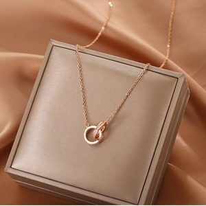 Macro detail of rose gold interlocking double rings necklace with sparkling crystal pave