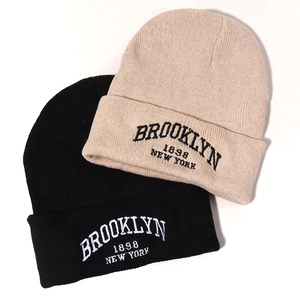 Knitted Brooklyn New York beanies in black and beige colors for winter fashion
