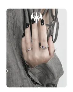 Detail of s925 silver chain rings with colorful zircon inlays on model hand