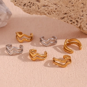Close-up of double layer wave ear cuffs in gold and silver finish on rock prop