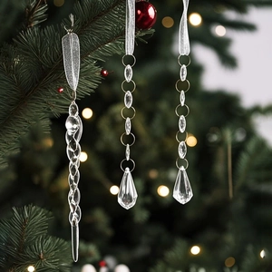Macro detail of transparent icicle and beaded droplet ornaments on a green Christmas tree