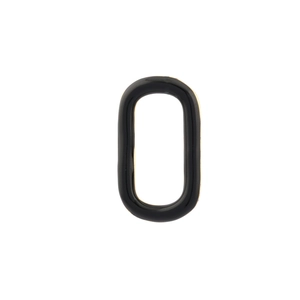 Macro detail of oval black enamel charm with polished gold frame for DIY jewelry making