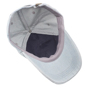 Detail view of denim baseball cap interior featuring cotton lining and metal buckle adjustment