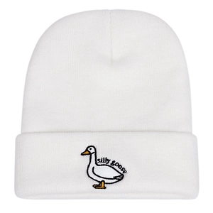 Detail view of the silly goose embroidery and fine knit texture on the white beanie hat