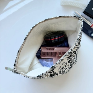 Internal view of floral canvas makeup bag showing storage space and fabric lining
