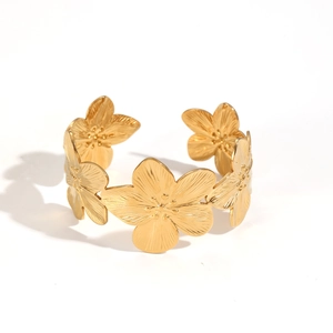 Detail view of the golden geometric flower bangle bracelet with open design feature