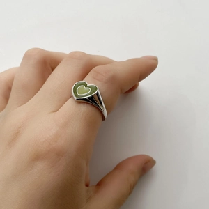 Close-up of double layer green enamel heart ring with silver stainless steel band