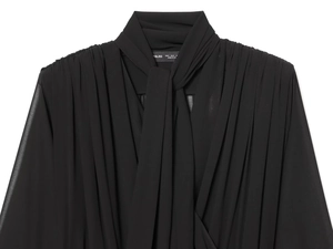 Detail of elegant black chiffon top neckline featuring tie-neck bow and delicate shoulder pleats