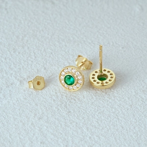 Detailed view of S925 silver halo earrings with emerald green stone and white crystals