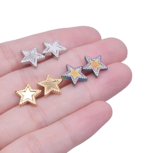 Detailed close-up of heart-shaped 304 stainless steel stud earrings in silver, gold, and rainbow